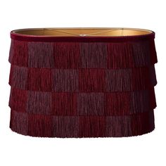 a red lamp shade with fringes on it