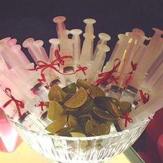 a glass bowl filled with lots of different types of toothbrushes on top of a table