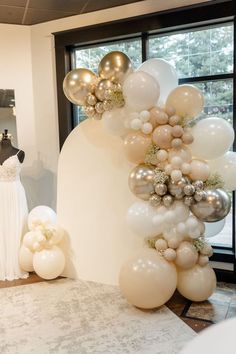 the balloon arch is decorated with silver and white balloons for a bridal party or wedding