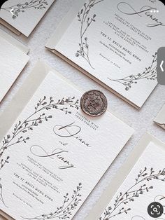 the wedding stationery is laid out on top of each other