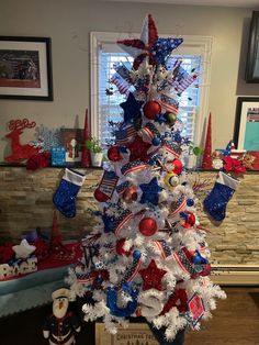 a christmas tree decorated with red, white and blue decorations