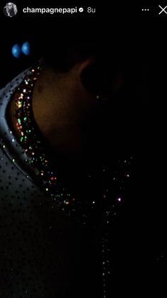 a close up of a person's neck in the dark with beads on it