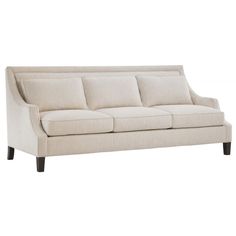 a white couch sitting on top of a wooden floor