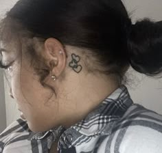 a woman with a tattoo behind her ear