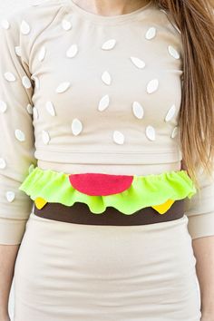 a woman wearing a dress with a hamburger belt around her waist