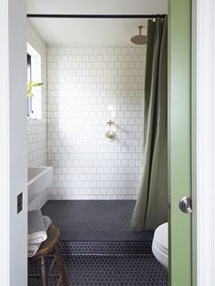 the bathroom is decorated in green and white