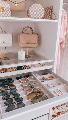 a white closet filled with lots of purses and handbags