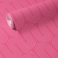 a pink wallpaper with white lines on it and a roll of tape next to it