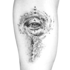 an eye and triangle tattoo on the thigh, with black ink overlaying it