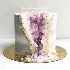 there is a cake with pink and white frosting on it