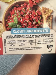 a person holding up a pizza box with different types of toppings on it's side