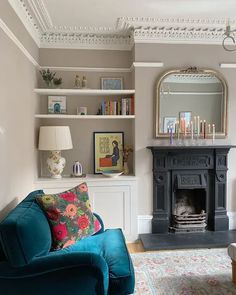 a living room filled with furniture and a fire place under a mirror on the wall