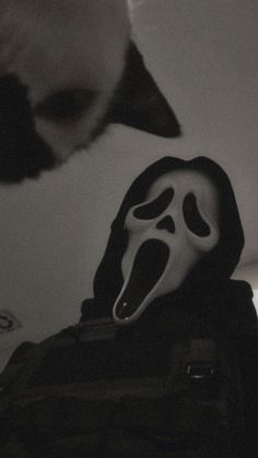 a black and white photo of a person wearing a mask