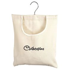 a white shopping bag with the word clothespins printed on it, hanging from a hook