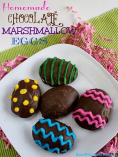 chocolate covered marshmallows on a white plate with pink and green streamers