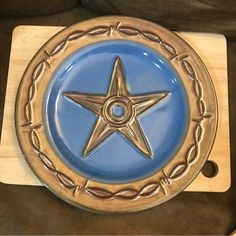 a blue and gold plate with a star on it