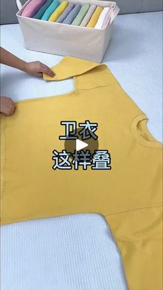 someone is holding up a t - shirt with chinese writing on the front and bottom