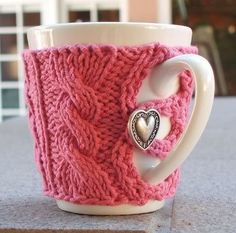 a knitted coffee cup with a heart on it