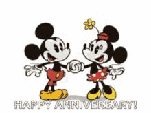 two mickey mouses standing next to each other with their arms around each other and holding hands