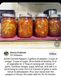 four jars filled with food sitting on top of a counter