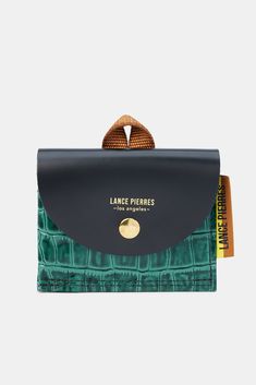 Envoy easily holds upwards of seven cards in a luxe glazed calf leather. A nylon webbing folded loop accent is a nod to the season's journey of exploration. DESIGN- A mini wallet in croc-embossed leather for credit cards and bills.- Flap closure with gold snap- Width: 4.25", Height: 3 1/2", Depth: 1.2"FABRIC & CARE- 100% calf leather- Ethically made in the U.S.A.SUSTAINABILITY- This product was created using a custom pattern to create the amount of material waste possible.- Designed and manu Snap Wallet, Mini Wallet, Credit Cards, Embossed Leather, Forest Green, Fabric Care, Calf Leather, Sustainability, Credit Card