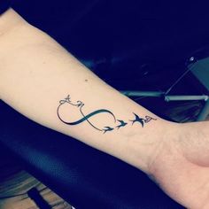 a person's arm with an arrow and three stars tattoo on the left wrist