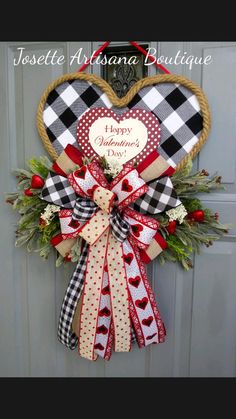 a heart shaped wreath hanging on the front door