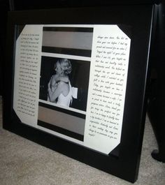 a black and white photo frame with an image of a woman holding a baby in it