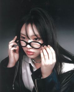 a woman wearing glasses and a black jacket