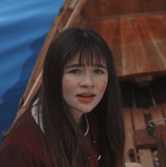 a woman standing in front of a boat