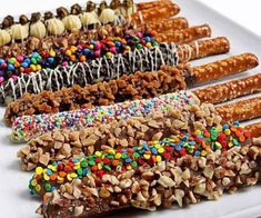 a white plate topped with lots of different types of candy bars covered in sprinkles