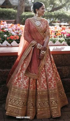 a woman in an orange and gold bridal gown