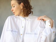 Vintage white cotton striped collar button up long sleeve blouse shirt. Long sleeves, gold tone buttons down the front, chest pockets, no lining. Material is cotton. Tag: BC Size 46 Will fit up to size XL Measured laying flat (double for circumference): 25.5'' / 65 cm long 24.5'' / 62 cm armpit to armpit 24'' / 61 cm waist 19'' / 48 cm shoulders 24'' / 61 cm sleeve length Great vintage condition. Two Tone Button Up Shirt, Fall Daywear Shirt With Striped Collar, Fall Season Striped Collar Shirt For Daywear, Chic White Shirt With Striped Collar, White Shirt With Striped Collar For Work, White Striped Collar Button-up Blouse, Daywear Button-up Blouse With Striped Collar, White Button-up Blouse With Striped Collar, Daywear Blouse With Striped Collar And Button-up Shape