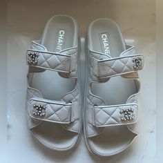 Bnwt Chanel 24p G45507b15805 White Backless Cc Logo Slide Dad Sandals, Size 38.5. Serial Number In Last Two Images. Brand New. 100% Authentic. Includes Box, Dust Bags, Cards. The Most In Demand Shoe On The Market From Chanel Spring Collection. Beautiful White Quilted Lambskin Leather With Cc Logo’s Made In Italy. All Sales Are Final. Item Will Be Shipped Insured Requiring Adult Signature. Chanel Slides Sandals, Chanel White Sandals, White Chanel Sandals, White Flat Platform Slides, Luxury Platform Slip-on Sandals, Luxury Slides With Removable Insole, Luxury Slip-on Platform Sandals, Designer White Sandals With Heel Strap, Luxury Slides With Platform And Round Toe