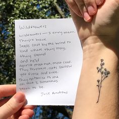 a person is holding up a piece of paper with flowers on it and the words wildflowers written in cursive writing