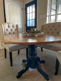 a wooden table with two chairs around it