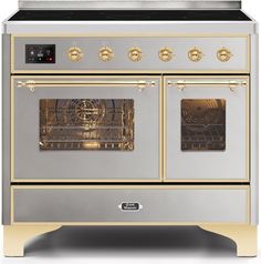 a white and gold stove with two ovens