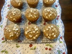 several muffins on a cooling rack with oats