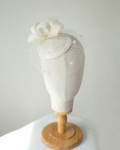 The millinery bridal hat is made of sinamay trimmed with bow trimming and birdcage veil. The veil on this pillbox is adorned with sweet little chenille dots. The hat attaches to the hair with flat hair comb from bottom side for easy placement to any hair style. Colours: light ivory (as pictured)  Also available in white, cream, lilac or beige sinamay for brides, black or navy for special occasion I make all my hats and trimmings using traditional millinery couture technique and patterns (not pre Adjustable Tulle Fascinator For Wedding, Adjustable Wedding Fascinator With Satin Bow, Tulle Hat For Weddings And Kentucky Derby, Adjustable Tulle Wedding Fascinator, Fitted Tulle Hats For Weddings, Elegant Tulle Mini Hats For Wedding, Adjustable Tulle Headpiece For Wedding, Adjustable Fascinator For Wedding, Wedding Costume Hats And Headpieces With Handmade Flowers