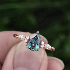 This is a 1.3 carat Lab treated alexandrite engagement ring in solid gold,about 6X8mm pear cut. The accent stones are round 1.5mm and marquise 2x4mm moissanites. It can be made in any ring size. However please contact me to custom make it to a special big or small size. It can be made in white gold,rose gold or yellow Alexandrite Engagement Rings, Alexandrite Rings, Gamer Wedding, Alexandrite Jewelry, Moissanite Wedding Ring Set, Wedding Rings Photos, June Birthstone Ring, Birthstone Rings, Alexandrite Engagement Ring