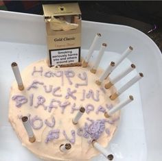 a birthday cake with candles on it sitting in a box