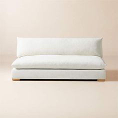 a white couch sitting on top of a wooden floor