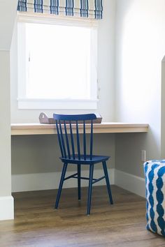 a blue chair sitting in front of a window