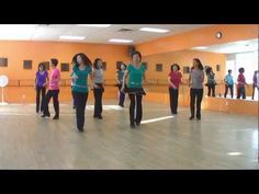 a group of young women standing on top of a wooden floor in a dance studio