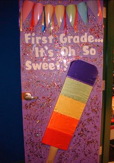 a bulletin board with a broom on it and some streamers hanging from the wall