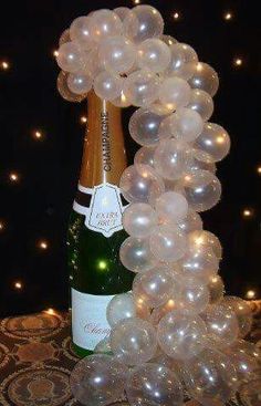 a bottle of champagne and some balloons on a table