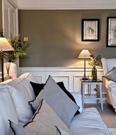 a living room filled with white furniture and pillows