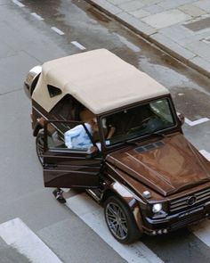 a car with a covered roof is parked on the street