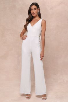 Walking in like you own the place is exactly how the Lulus Feeling Sparkly White Sequin Bow Wide-Leg Jumpsuit is supposed to make you feel! This fabulous jumpsuit is sure to make you the shiniest sight in any room with its dazzling white sequin composition that shapes a princess-seamed bodice with a V-neckline and a flirty open back design, all supported by wide straps. The high fitted waist tops trendy wide pant legs that fall to ankle-grazing hems. The dramatic, oversized bow detail at the back is sure to make heads turn and secures via snap closures for easy on-and-off! Hidden back zipper/clasp. Fit: This garment fits true to size. Length: Floor length. Size medium measures 57" from shoulder to hem. Inseam: 31.25 Front Rise: 13.75 Bust: Great for any cup size. Waist: Fitted - very fitte Glamorous White Sequined Jumpsuits And Rompers, Glamorous Sleeveless Jumpsuits And Rompers For Wedding, Glamorous Sleeveless Jumpsuits For Weddings, Glamorous Sleeveless Wedding Jumpsuits And Rompers, Party White Sequined Jumpsuits And Rompers, Bow Jumpsuit, Tops Trendy, Lulu Fashion, Sequin Bow