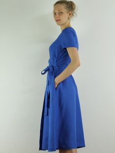 "Spring dress, Write the selected color in the message Handmade blue bayou wrap dress with short sleeves, 2 pockets and belt , perfect for casual wear and suitable for any occasion in any season Details: - 100% natural linen produced in Europe ; - medium weight (180 gram per square meter); - color: blue bayou , could be any from our colors catalog (color samples at the photo); Made to order, approximately a few days, If you have any questions please message me and I will be glad to answer. Size Summer Wrap Dress With Short Sleeves For Vacation, Summer A-line Belted Wrap Dress, Elegant Blue Linen Dress With Short Sleeves, Belted Short Sleeve Wrap Dress For Beach, Short Sleeve Belted Wrap Dress For Beach, Belted Wrap Dress With Short Sleeves For Beach, Blue Short Sleeve Wrap Dress For Spring, Blue Belted Short Sleeve Dress, Summer Dress With Belt And Short Sleeves